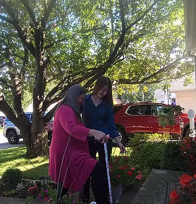 A photagraph of an O.T. helping a person up stairs
